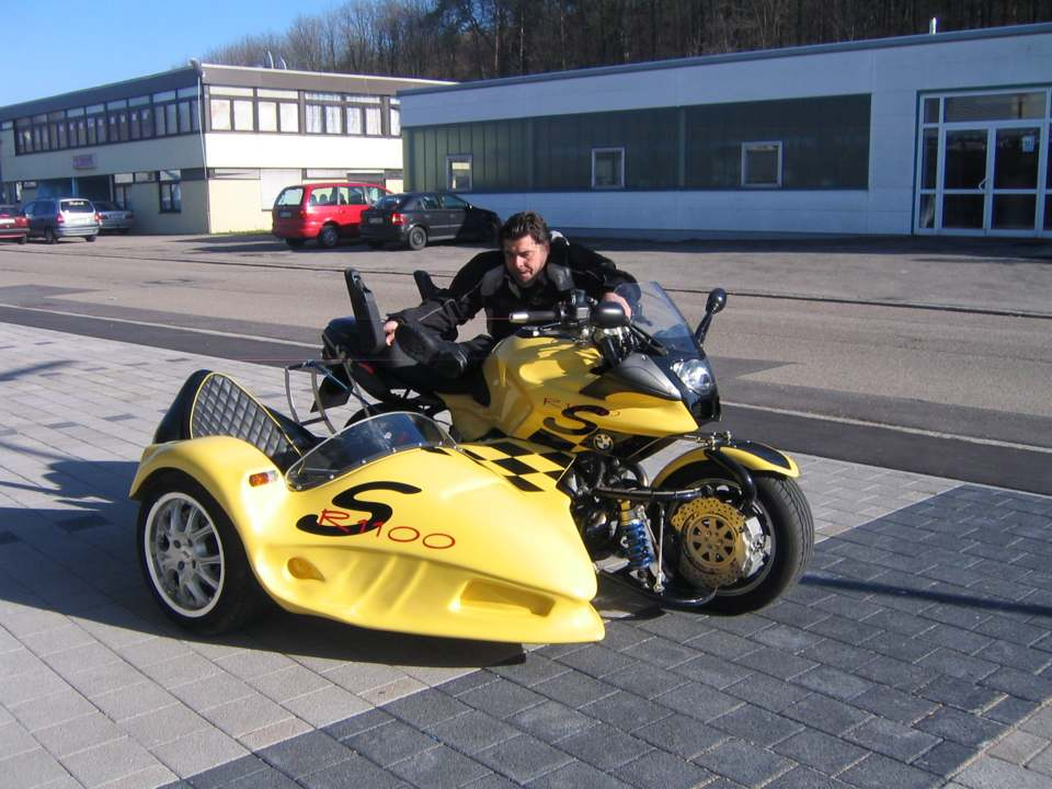 person an a Wheelchair in the climb on a sidecar motocycle