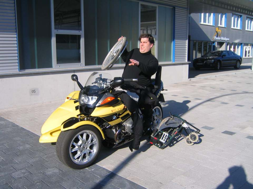 person in a Wheelchair load his on a sidecar motocycle