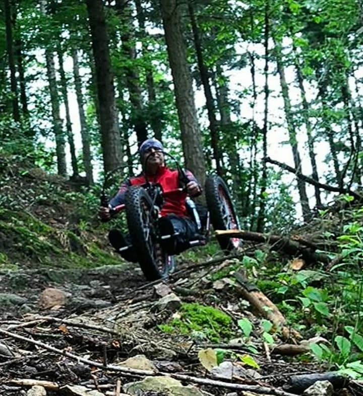 handbiker in the forest downhill